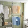 SoBuy Garderobenständer KLS04-HG mit Regalen: Kleidung in Pastelltönen aufgehängt vor grüner Wand Produktbild-Vorschau