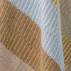 A close-up view of a striped blanket made of recycled cotton. Produktbild-Vorschau