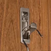 A silver hook mounted on a wooden surface. Produktbild-Vorschau