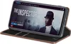 A smartphone displaying a movie poster is placed in a dark brown leather flip case. Produktbild-Vorschau