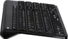 A black wireless keyboard and mouse set is shown from a diagonal, slightly elevated angle against a white background. Produktbild-Vorschau
