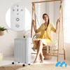 A woman is sitting in a hanging chair next to a white oil radiator. Produktbild-Vorschau