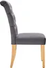 A side view of a single gray upholstered dining chair with wooden legs. Voir les images du produit