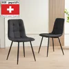 Two black dining chairs with tufted seats and black metal legs in a room. Náhled obrázku produktu