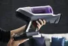 A person is holding a cordless vacuum cleaner with a purple dustbin. Voir les images du produit