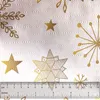 A close-up view of a white textured surface with gold Christmas-themed decorations, including stars and snowflakes, and a ruler at the bottom. Produktbild-Vorschau