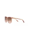 A pair of pink Michael Kors sunglasses with brown lenses, shown from the side on a white background. Produktbild-Vorschau