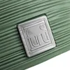 A close-up view of a green textured surface with a silver embossed logo. Voir les images du produit