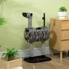 A cat is inside a zebra-themed cat tree in a room with plants and furniture. Produktbild-Vorschau