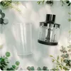 A blender attachment and a beaker are placed on a white surface with green foliage and shadows. Náhľad obrázku produktu