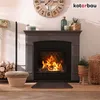 A cozy living room scene with a fireplace, logs, and decorative items. Produktbild-Vorschau