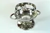 A stainless steel and glass fondue pot with a stand. Produktbild-Vorschau
