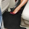 A woman's legs and feet in red high heels are shown inside a car, resting on black floor mats. Produktbild-Vorschau
