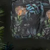 A close-up view of a dark-colored duvet cover with a floral and leaf pattern. Produktbild-Vorschau