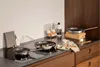A kitchen counter with cooking ingredients and pans. Náhled obrázku produktu