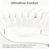 Close-up of a white tufted upholstered product with gold accents, featuring a feather and text overlays. Produktbild-Vorschau