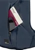 A close-up view of a dark blue backpack pocket with a phone and a city guide book inserted. Produktbild-Vorschau