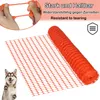 A roll of orange plastic safety netting is shown, with a close-up of hands stretching a piece of the netting in the upper left corner. A husky dog is also visible in the lower left corner. Náhled obrázku produktu