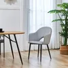 A dining chair is placed next to a dining table in a well-lit room with sheer curtains in the background. Produktbild-Vorschau