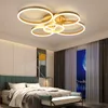 A bedroom with a modern ceiling light fixture above a bed. Náhled obrázku produktu