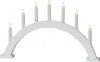 A white arched candle bridge light with seven electric candles. Produktbild-Vorschau