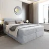 A modern bedroom with a large bed as the focal point. Produktbild-Vorschau