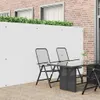 A white privacy screen is installed on a patio, with outdoor furniture in front of it. Produktbild-Vorschau