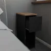 A narrow black nightstand with a wooden top and one open drawer is placed next to a bed. Podgląd zdjęcia produktu