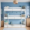 A child's bedroom with a triple bunk bed, decorated with nautical-themed artwork and a garland. Náhľad obrázku produktu
