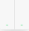 A close-up, front-facing studio shot of a white, dual-gang light switch with two green indicator lights. Voir les images du produit