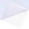 A close-up view of a white self-adhesive film with a grid pattern on the back. Produktbild-Vorschau