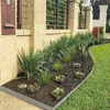 A garden bed with plants and a metal border next to a lawn. Náhled obrázku produktu