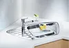A corner kitchen sink with a faucet, cutting board, knife, and lemons. Náhled obrázku produktu