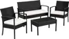A black rattan seating group with white cushions, consisting of a two-seater sofa, two armchairs, and a coffee table, displayed on a white background. Náhled obrázku produktu