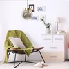 A cozy bedroom corner with a chair, dresser, and lamp. Produktbild-Vorschau