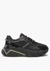 A black Guess sneaker with gold accents is shown against a white background. Produktbild-Vorschau