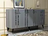 A modern gray sideboard with silver accents, displayed in a well-lit room with a floor lamp and artwork in the background. Anteprima dell’immagine prodotto