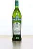 A bottle of Noilly Prat Original Dry Vermouth is shown against a white background, standing on a wooden surface. Produktbild-Vorschau