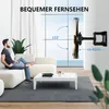 A man is relaxing on a couch in a modern living room, with a TV mounted on the wall. Podgląd zdjęcia produktu