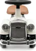 A front view of a white toy car with a brown seat and black steering wheel. Produktbild-Vorschau