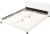A white bed frame with a slatted base, shown from a diagonal angle against a white background. Náhľad obrázku produktu