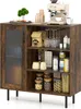 A wooden sideboard with a glass door, filled with various items like coffee machine, wine glasses, jars, and pasta. Náhľad obrázku produktu