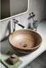 A modern bathroom sink with a faucet and decorative elements. Náhľad obrázku produktu