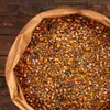 A close-up view of a bag of birdseed, showing the mixture of grains and seeds. Produktbild-Vorschau