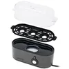 An egg cooker disassembled into its main components: the base, the steaming rack, and the lid. Anteprima dell’immagine prodotto