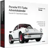A white Porsche 911 Turbo model is shown on a white background, with text and logos indicating it is an advent calendar. Náhled obrázku produktu