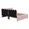 The back view of a pink upholstered bed frame with a scalloped headboard on a white background. Náhľad obrázku produktu