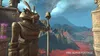 A statue of a creature holding a staff stands in front of a volcanic landscape. Produktbild-Vorschau