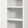 A close-up view of the interior of a white metal cabinet with shelves. Voir les images du produit
