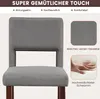 Close-up of a gray upholstered chair with wooden legs, highlighting fabric texture and foam padding. Produktbild-Vorschau